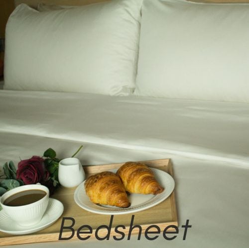 Comfortable bedsheet with breakfast tray, coffee, and croissants for a cozy experience at a luxury hotel or home. Perfect for relaxing mornings and quality sleep.